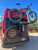 Aluminess BackPACK rear mounting plate equipped on a red Ford Transit van.