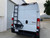 Rear door view of an white Dodge RAM Promaster featuring Aluminess Rear Door Ladder.