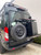 Rear view of a black Ford Transit van featuring Aluminess Driver Side Rear Door Box/Tire Rack.