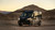 Transit van featuring Fiamma Roof Rack Awning parked in a desert landscape.