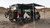 Rear view of van with Fiamma Roof Rack Awning extended, camping setup with bikes.