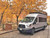 Front view of a silver Ford Transit van featuring Aluminess Weekender Roof Rack.
