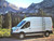 Side view of a white Ford Transit van featuring Aluminess Weekender Roof Rack.