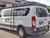 Side view of a white Ford Transit van featuring Aluminess Weekender Roof Rack.