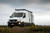 Sprinter van parked featuring Aluminess Weekender Roof Rack.