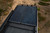 Top-down view of a parked Sprinter van featuring Aluminess Weekender Roof Rack.