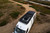 Front view of a parked Sprinter van featuring Aluminess Weekender Roof Rack.