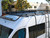 White Dodge RAM Promaster with a Touring Roof Rack.