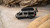 Beige Mercedes Sprinter van outfitted with several off-road accessories, parked near open canyons.