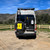 Close-up rear view of a Sprinter van featuring Saved By The Tire.