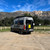 A three-quarter rear view of a Sprinter van featuring Saved By The Tire.