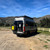 A three-quarter rear view of a Sprinter van featuring Saved By The Tire.