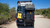 Rear view of the PowerLift Trail Caddy mounted on a van, carrying a cooler and an axe.