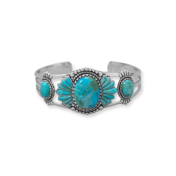 All eyes will be on you! Oxidized sterling southwest style silver cuff bracelet features deco detailing and rich, vibrant reconstituted turquoise. The center stone measures 20mm x 15mm and is edged with fancy cut stone, accent oval stones measure 8mm x 10mm.

.925 Sterling Silver