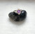 Sterling silver and amethyst etruscan style ring on top of rock