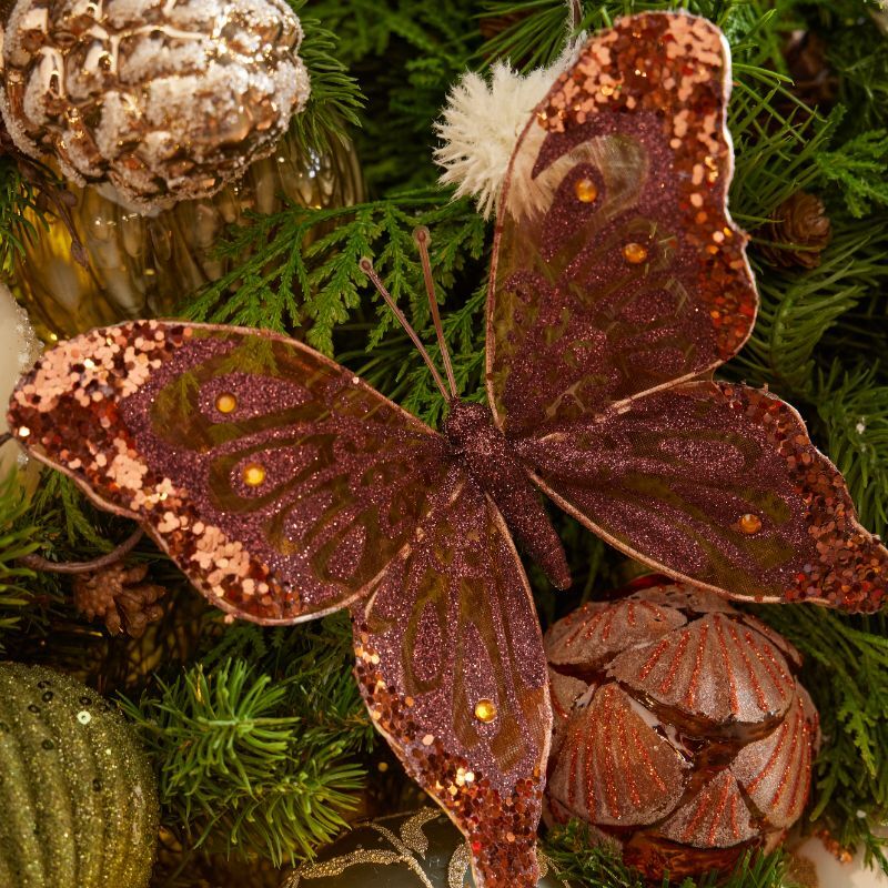 Copper glitter butterfly among forest greens