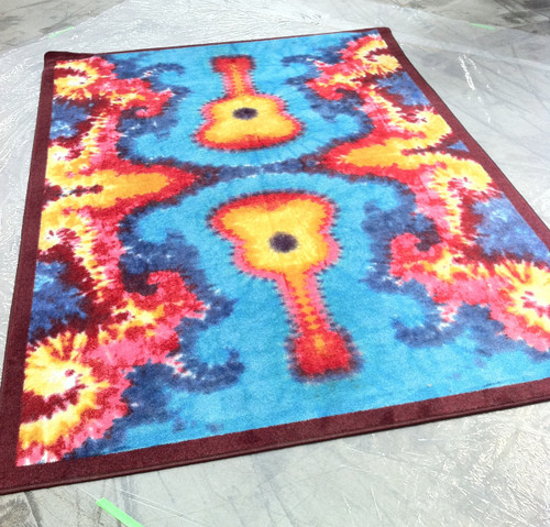 American Dakota Tie Dye Guitar rug with bright guitar silhouettes and swirling blue, red and yellow color