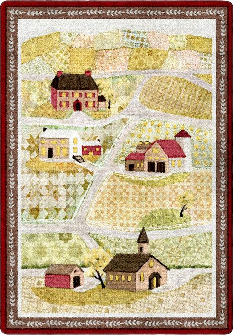 American Dakota Summer Fields Quilt rug with small houses, a church and pale yellow-and-green patchwork fields inside a red border