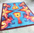 American Dakota Tie Dye Guitar rug with bright guitar silhouettes and swirling blue, red and yellow color