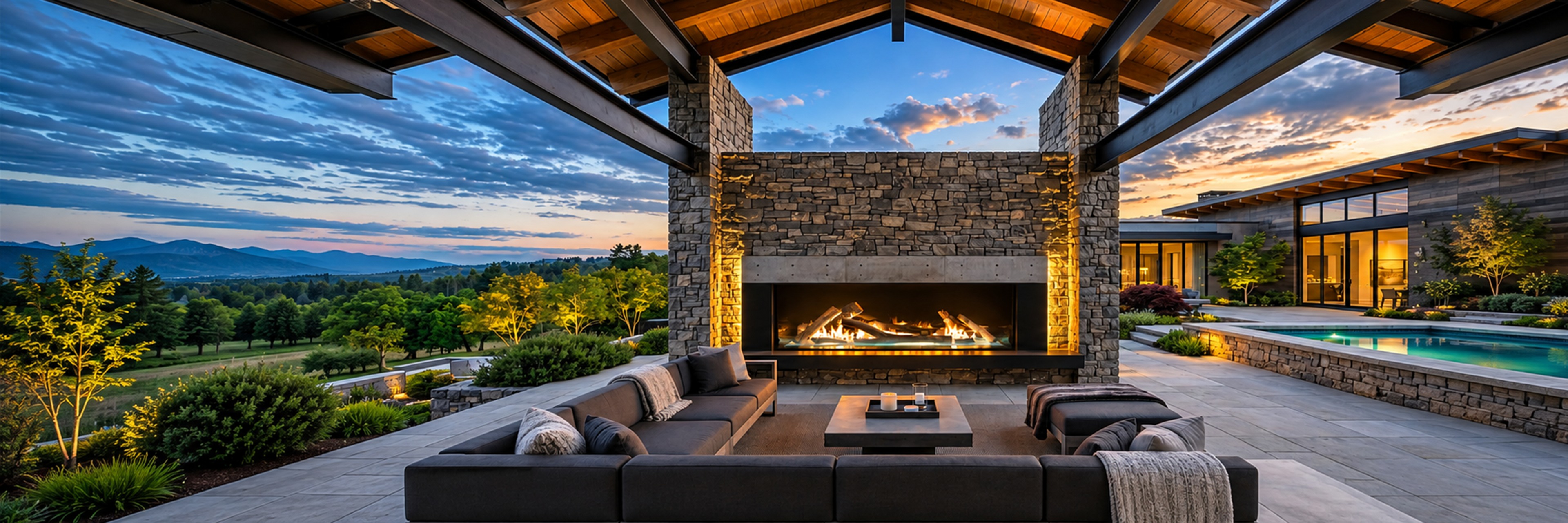 Modern covered outdoor living space with a large stone fireplace
