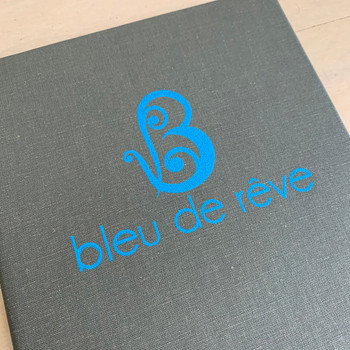 Screenprinted artwork on a Cambridge Linen Dark Grey Menu Cover