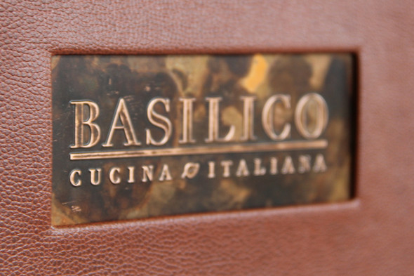 Embossed logo on copper menu cover.