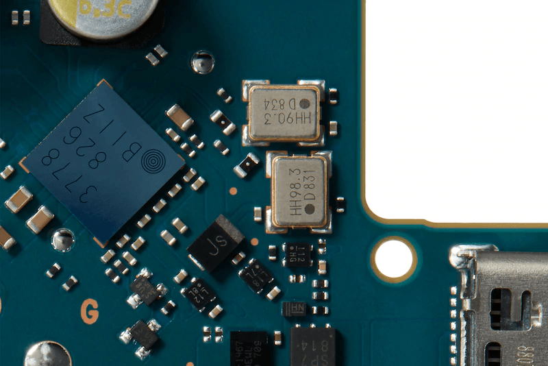 close up of circuit board with crystal oscillators