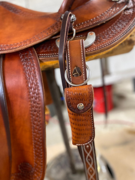 Hoof pick case can easily be attached to a pull strap on saddle.  Any tooling viewed on our website can be put on your hoof pick case.