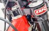 BRP Rubber Mounted Top Clamp, 2-stroke BRP Top Clamp uses 4 Poly-Urethane damper bushings Reduces rider fatigue & isolates harsh terrain vibration Softens the harsh spikes from hitting square edge obstacles 4-post design helps prevent twisting of the bar mounts Two sets of poly urethane bushings: red (medium) & blue (soft) Adjustable bar position in 14mm & 21mm settings BRP products are designed & Made in USA Fits 2013+ 250/300 RR 2-strokes