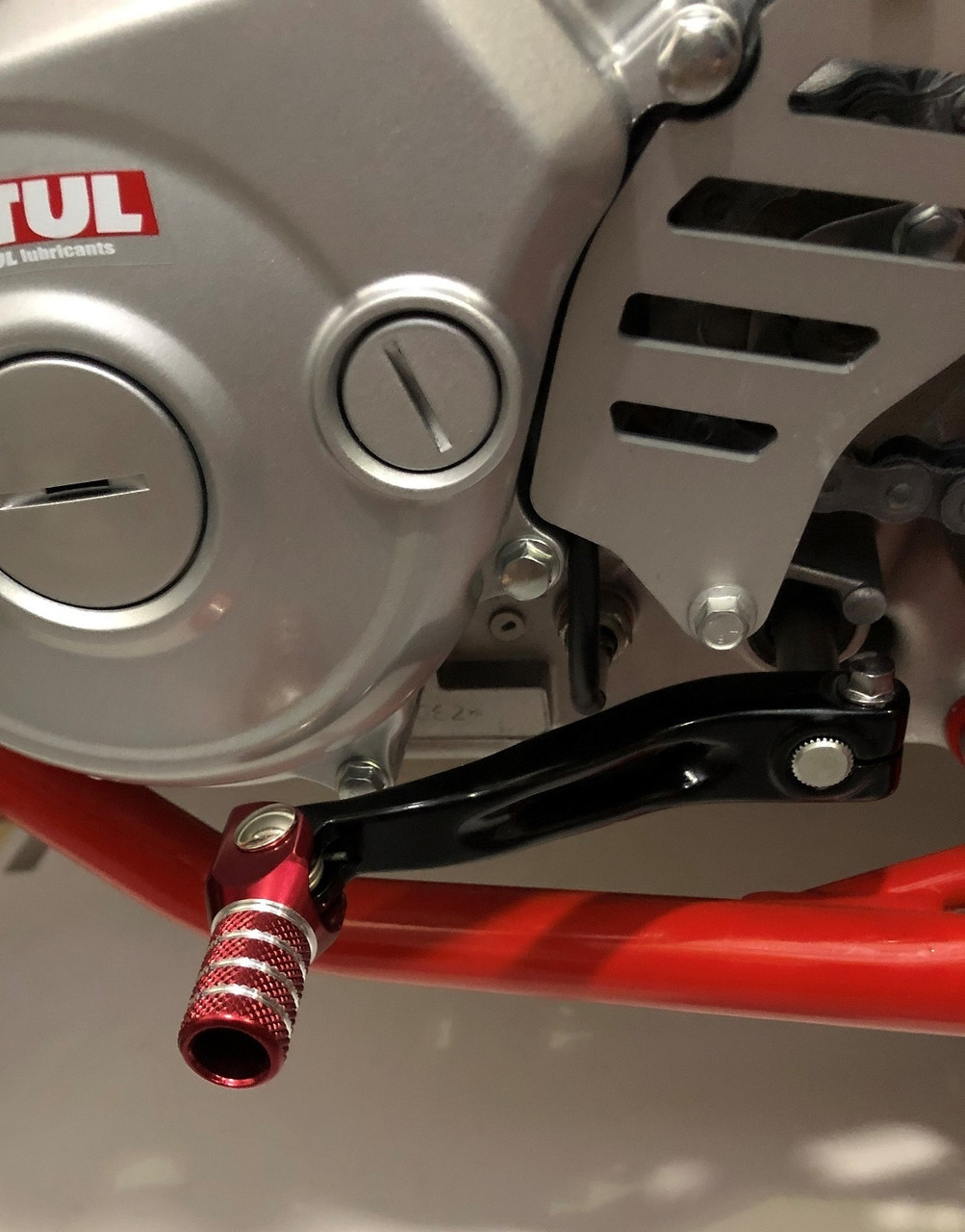 125 RR-S Heady Duty Shift Lever made from billet aluminum. Includes a spring loaded folding red tip that has been knurled for added grip.