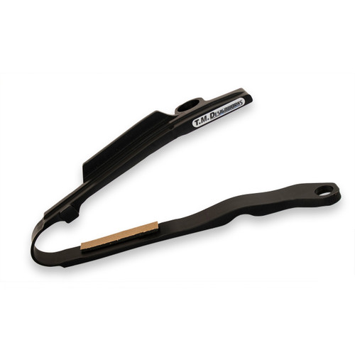 TMDesigns Composite Chain Slider, Black TMD precision made slider with exclusive oil additive low friction material TMD's rear plate tab keeps the chain in line & reduces loose chain problems TMD slider material lasts longer than softer (quieter) stock sliders TMD products are designed & Made in USA Stock chain guard Must be removed to fit TMD Slider