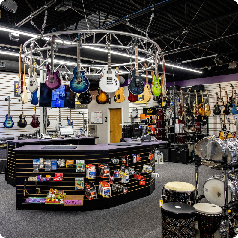 The inside of a Music Go Round Store with drums and guitars on display 