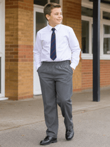 Boy wearing boys plus fit grey full elastic waist school trousers in a natural school uniform lifestyle image