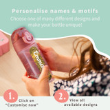 A child holding a pink personalised water bottle with the name Emma
