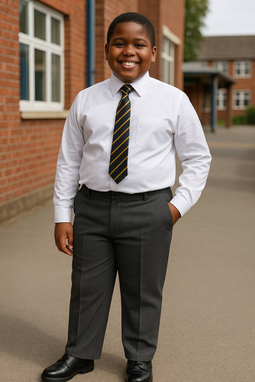 A cheerful boy aged around 9 is shown wearing Zeco Boys' Sturdy Fit School Trousers in a school playground setting. Tailored for boys who need a more generous cut, these trousers offer a wider fit at the waist and a slightly shorter leg length for all-day comfort and ease of movement. Captured in a natural school environment, the image highlights the practical, inclusive design ideal for a smart and confident school look.