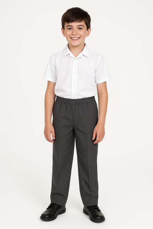 A 10-year-old boy wearing full elasticated grey school trousers and a white short-sleeve shirt, standing confidently against a white background.