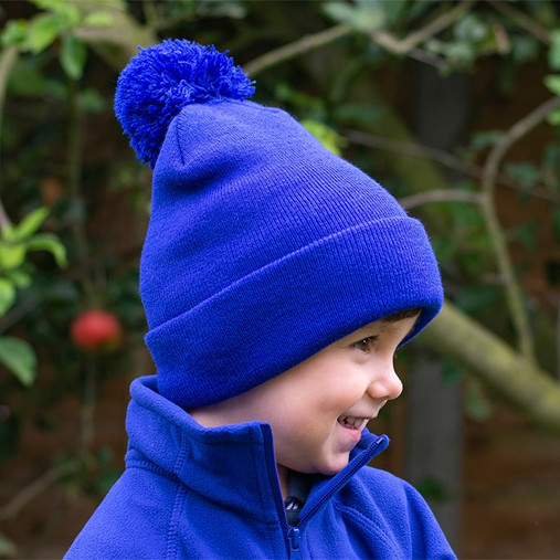 Child's navy knitted pom pom bobble hat with a deep turn up cuff