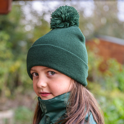 Child's navy knitted pom pom bobble hat with a deep turn up cuff