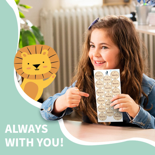 Girl smiling with a sheet of Easy2Name Jollein round name stickers