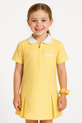 Bright and sunny, this gold gingham school dress offers a cheerful twist on schoolwear. It includes a matching scrunchie, white piping trim, and a front zip for easy dressing.