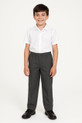 A 10-year-old boy wearing full elasticated grey school trousers and a white short-sleeve shirt, standing confidently against a white background.