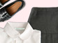 Woven name tape sewn into a school shirt collar, with a pinafore and school shoes
