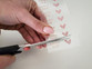 Cutting a single iron-on name transfer from the sheet with scissors