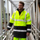 Orange and black 2-tone hi vis coat with reflective bands, storm flap pockets and stand-up collar