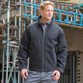 Black mens softshell work jacket with zip through collar, zipped pockets and treble stitching