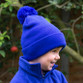 Child's navy knitted pom pom bobble hat with a deep turn up cuff