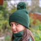 Child's navy knitted pom pom bobble hat with a deep turn up cuff