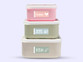 Three stacked lunch boxes labelled with Easy2Name one colour name stickers