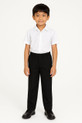 Boy aged 8 wearing black pull on school trousers with an elasticated waist and a white shirt