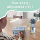 Child at a table with a checked pattern lunch box and a matching personalised water bottle